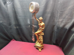 Large figurine with swinging pendulum musical clock in good working order. H.67 W.16 Cm.