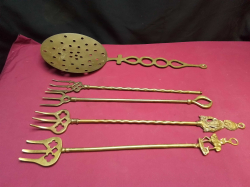 4 Brass toasting forks, and a Brass cream skimmer. 