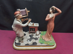 A Supers Quality Signed Capodimonte Figure of a Photographer and a beautiful Model A/F to base. W.30 D.18 H.26 Cm.