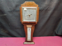 An Oak Baronmeter and Thermometer. H.44 W.18 Cm.