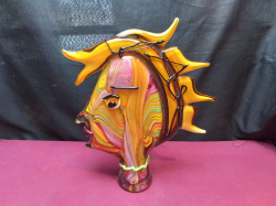 A Murano Glass figurine from Italy, specifically a colorful sculpture of a woman's head, often inspired by modernist artists like Picasso. These hand-blown art pieces feature intricate swirling patterns of pink, yellow, and orange glass. W. 28 H.39 Cm. 6 