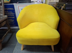 A very Clean yellow bedroom tub chair.