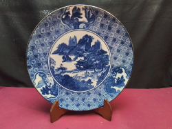 A Large Chinese blue and white plate 30cm. diameter  on wooden stand.   