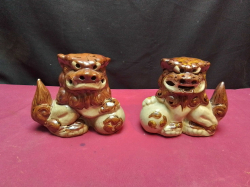 A pair of Chinese ceramic foo dogs. W.16 H.12 Cm.