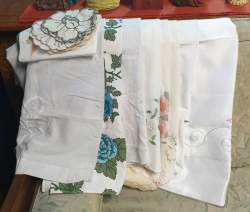 A large collection of old linen and lace tableware items