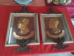 A  Copper Colored Portrait of King Rama 9 and Queen Sirikit, accompanied by a small Garuda figurine. 34X56 Cm.
