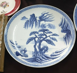 A large oriental blue and white porcelain charger in good condition W.35 Cm.