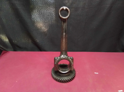 An engine coh rod Attached of A gearbox Cog Lacquered.