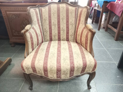 An Antique Armchair Crafted in the French Louis Style. Featuring carved walnut wood Frame and Striped Upholstery seating and backrests.  W.70 D.55 H.80 Cm. 