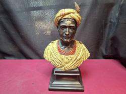 A Bronze cold painted bust of a blackamoor on an integral square stepped base, height 39cm. 

