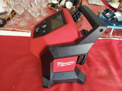 A Milwaukee M12 Compact Inflator, a cordless portable air compressor.