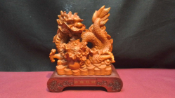 A Resin of Chinese Dragon and Coins on a Stand. W.16.5 H.19 Cm.