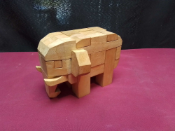 A Small Wooden Puzzle Elephant. L.13 H.10 Cm.
