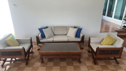 An antique hand carved  Thai 3 piece settee with brand new upholstered never used and hand carved coffee table with glass top. W.63 L.126 H.42 Cm.  (4 pieces)