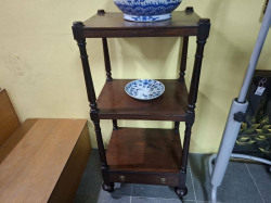 An English Regency c,1830 mahogany 3 tier whatnot with the original draw below. Standing on the original legs and Casters. D.38 W.48 H.102 Cm.