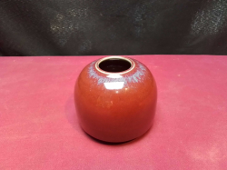 A Small red glazed pottery vase. W.9 H.7 Cm.