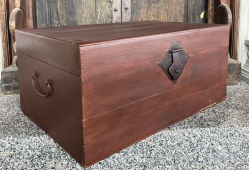 A solid wooden storage chest with a decorative iron lock mechanism D.47 W.70 H.32 Cm.