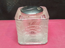 A moulded Glass table lighter. W.6 H.6.5 Cm. 