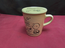 A very rare and collectible snoopy and Charlie brown cup with ceramic lid.