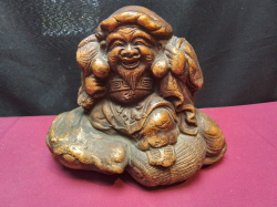 A Terracota Statue of Daikokuten The Japanese God of Wealty. W.20 H.16 Cm.