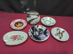 Assorted pin trays and decorative plates One is a raised design of a duck wall hanging. One is world of art item And one is a free standing Chinese item all