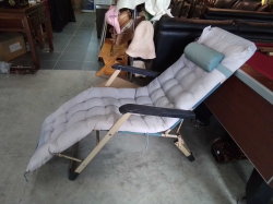 A folding patio sun lounger  with fitted cushion.