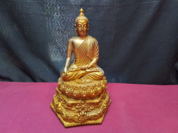 A large golden statue of Buddha. W.20 H.19 Cm. 
