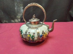 A decorative Chinese silver and porcelain teapot with Eight Immortals motif. W.15 H.15 Cm. 