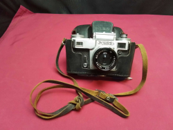 A Large black Photo Camera with case