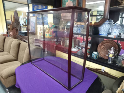 A large high quality of curve plastic show case with a dark wood frame. L.101 W.34 H.93 Cm. In Good Condition.