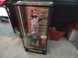 A Japanese glass display box  with a music and contents. D.24 L.39 H.80 Cm.