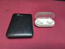 Portable external hard drive and Sony Wireless Earbud Charging case.