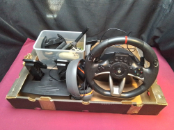 A Box of Steering Wheel/ Pedals/ Headphones PS Sing Star Camera.