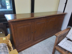 A mid-century cherry wood sideboard is designed in a French Regency Louis XVI style and features original brass hardware. D.50 L.220 H.93 Cm.