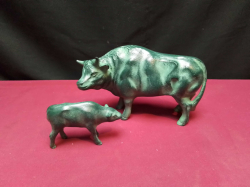 A cast iron cow W.16 H.9 Cm. with baby Statue.