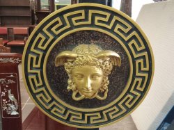 Versace motif wall plaque features a golden Medusa Head. W.50 Cm.
