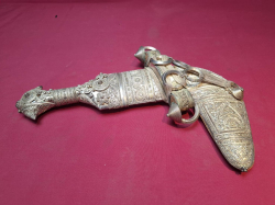 A vintage Arabian silver ceremonial dagger in ornate sheath 30cm long