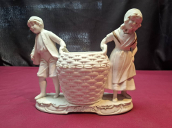 A vintage German bisque figurine of children with large basket