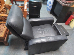 A black Furdini Muze manual recliner features thick foam padding and high-quality PVC leather.