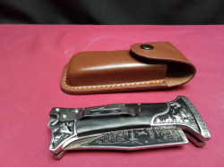 High quality silver black carved folding knife (made in USA) with leather case.