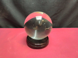 A vintage Oriental crystal ball on stand. W.10 H.12 Cm.