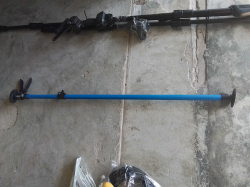 A telescopic Support Rod designed for holding materials like drywall in place during Construction.