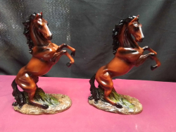 A pair of resin rearing horses figurings in exalent condition 23 Cm. high on stands.