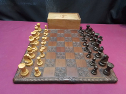 A vintage Chess set with a carved handwood board.
