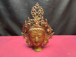 An antique decorative brass Tibetan Buddha head sculpture with colorful Inliads. W.16 H.21 Cm.
