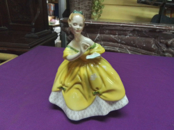 A Royal Doulton figure in yellow 
