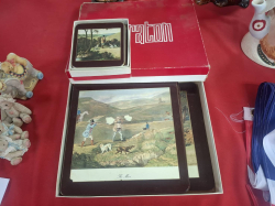 A Box of Prety table mats and a set of coasters. Approx. 28x23 cm