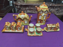 A collection of farmhouse China 5 pieces including tea pot, coffee pot and an egg crust.