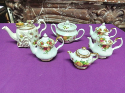 A good selection of Unusual Old Country Rose Doulton Pottery 4 miniature tea pots a 2 Handled sugar and a very rare small ornate tea pot