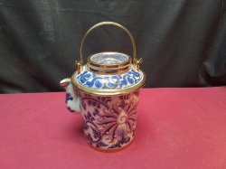 A decorative Thai Benjarong porcelain teapot features intricate blue and red floral patterns with gold highlights and lid. W.14 H.20 Cm.